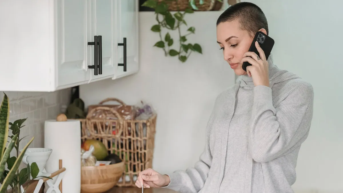Calm person at home on the phone with a licensed professional about debt help on disability