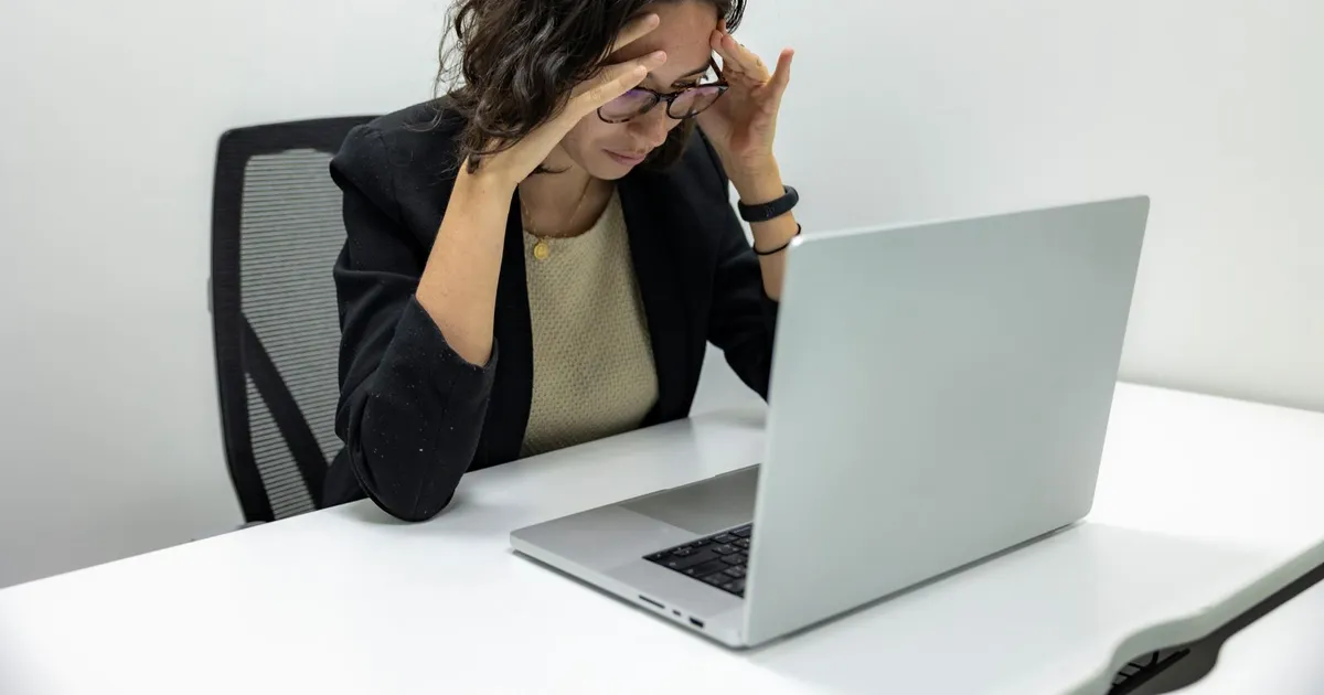 Person searching for work on a laptop at home while sorting out the debt help unemployed Canadians can use