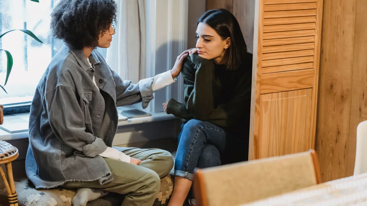 Supportive conversation between a counsellor and a client about low income debt help options