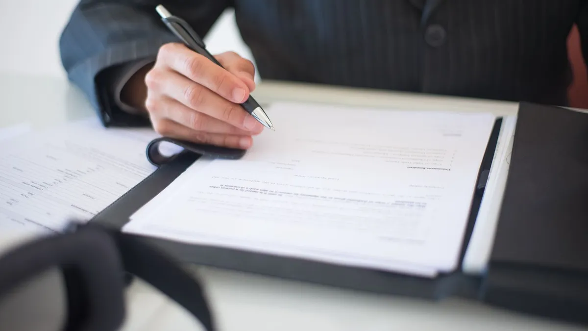 Relieved man reviewing a settlement letter confirming a creditor agreed to write off debt